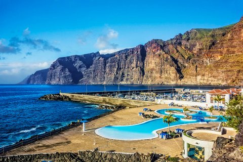 Blick vom öffentlichen Schwimmbad in Acantilados de los Gigantes (die Klippen der Riesen) auf Privatpool, Yachthafen und Los Gigantes